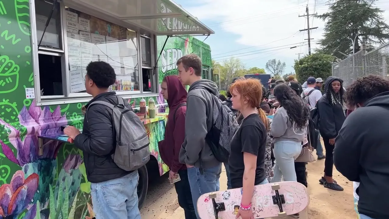 A line of customers waiting at the Serranos Taco Truck service window