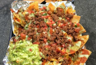 Loaded nachos with seasoned beef, pico de gallo and guacamole