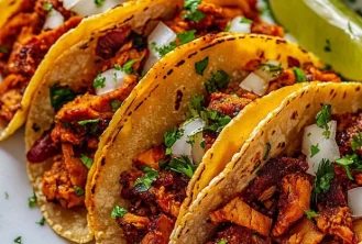 Tacos filled with marinated pork, onions and cilantro